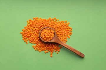 Red lentils on the spoon - Lens culinaris organic.