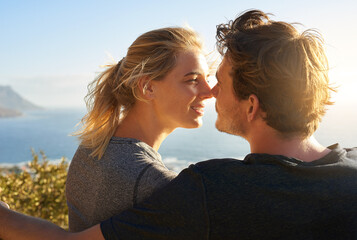 Love, nose touch and couple at beach on holiday for trust, care or bonding together on vacation....