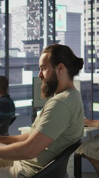 Vertical video Developer working with artificial intelligence machine learning tech, improving company systems. IT expert in office focused on transforming data into predictive models, camera B