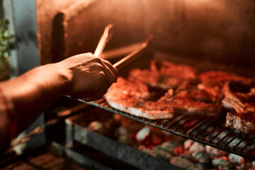 Hands, meat and grill for barbecue, celebration and event on weekend or holiday with fireplace....