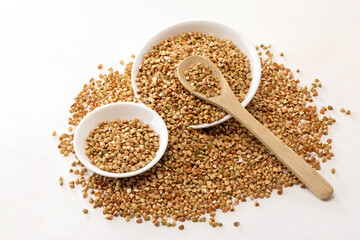 green buckwheat grain isolated on a white background