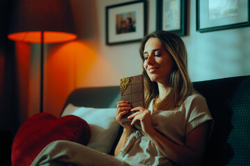 Naklejka premium Woman Holding a Chocolate with Pistachio filling. Happy smiling lady indulging with a huge bar of chocolate 