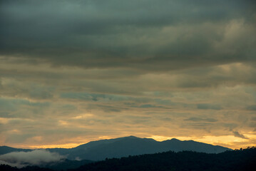 Beautiful Mountain landscape foggy windy mountain range green landscape asian farm. Amazing Landscape mountain green field meadow white cloud blue sky on sunrise. Countryside sunlight heaven scenery