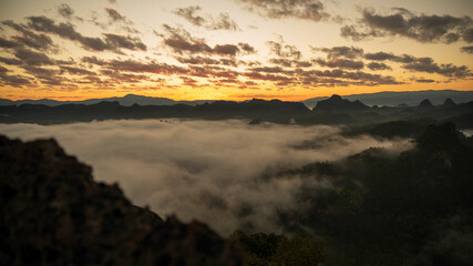 Sunset mountain range beautiful landscape mist foggy sunrise beam. Golden sky Mountain landscape foggy windy mountain. Amazing Landscape cloud sky on sunrise. Countryside gold sunlight heaven scene
