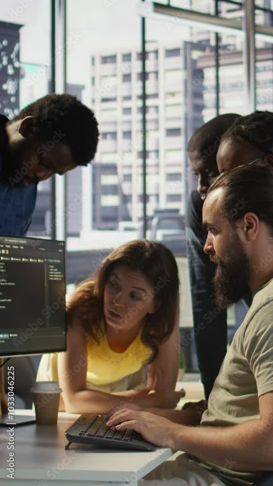 Poster vertical video programmers gathered together to conduct code review to fix errors, identifying techn