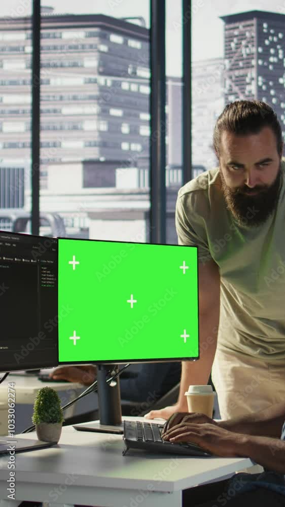Poster vertical video developer using mockup pc, being assisted by colleague to fix applications issues, de