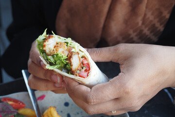 Enjoy a Delicious Chicken Wrap Filled with Fresh and Crunchy Vegetables for a Meal