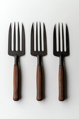 Naklejka premium Three garden forks, white isolate background