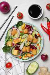 Fried tofu salad with vegetables and sauce top view