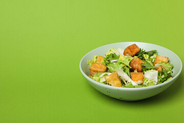 Fried tofu salad on a green background