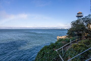 A rainbow arches over San Francisco, seen from Alcatraz Island, showcasing the city's skyline and...
