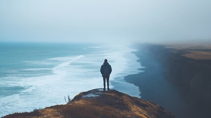 A Solitary Figure Stands on a Cliff Overlooking the Ocean