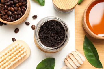 Coffee body scrub, in a container with whole coffee beans, on a white background.
