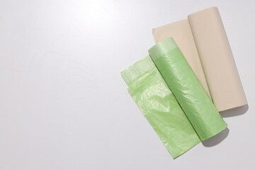 Rolls of garbage bags on white background, space for text