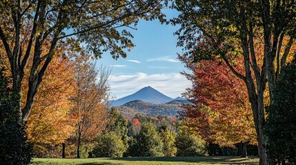 Fototapeta premium A mountain peak viewed through a frame of fall foliage.