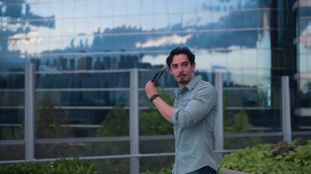 Man Traveler Walking Through Seoullo 7017 Skygarden at Sunset, Take off Sunglasses and Admire Skyscrapers - tracking shot