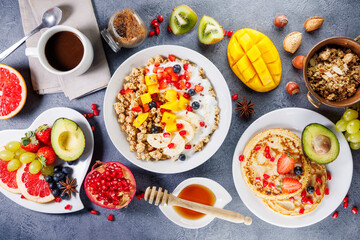 healthy breakfast food table with muesli, fresh fruits, pancakes and coffee cup