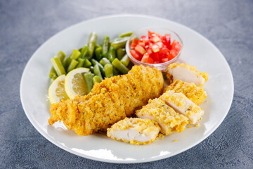 homemade breaded chicken tenders with beans and tomatoes