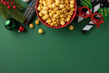 A festive setup for a Christmas movie night featuring a bowl of popcorn, holiday decorations, and...