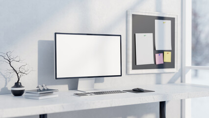 Fototapeta premium A computer and decor on a white table against a white wall with a memo board on it.