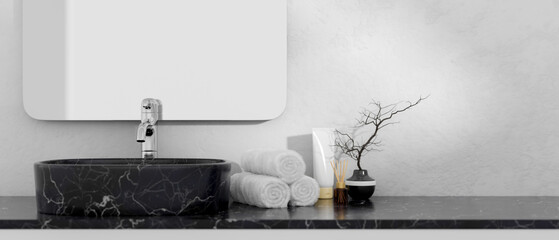 A black marble bathroom vanity featuring a black marble basin and a mirror on the white wall.