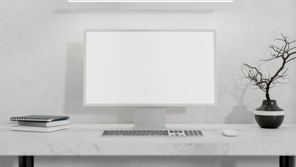 A computer with a white screen mockup and decor on a white table against a white wall.