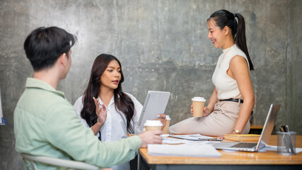 A gorgeous Asian businesswoman is sharing her ideas with her team during a meeting.