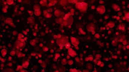 Abstract red bokeh lights on black background.