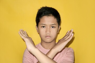 A teenager is crossing their arms.
