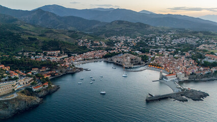 Collioure town and bay in Mediterranean sea, south of France, aerial shot at dusk