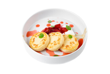 Syrniki or cheese pancakes with cream sauce and strawberry jam in white plate on white background