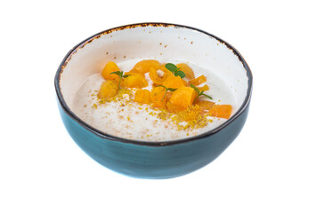 Oatmeal with milk served with fresh apricot on a white background top view