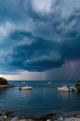 Severe storm clouds gathering over a coastal area, signaling extreme weather