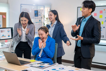 A group of people are celebrating in a business setting