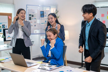 A group of people are celebrating in a business setting