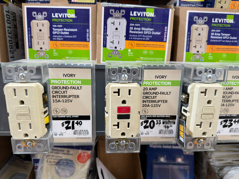 Variety of GFCI outlets on display inside a home improvement store.