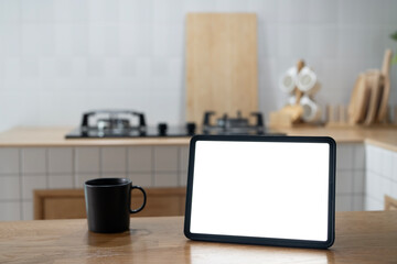 Open laptop with blank screen on a wooden desk in a kitchen room home office