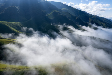 Landscape of Morning Mist with Mountain Layer at north of Thailand. mountain ridge and clouds in rural jungle bush forest