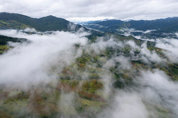 Landscape of Morning Mist with Mountain Layer at north of Thailand. mountain ridge and clouds in rural jungle bush forest