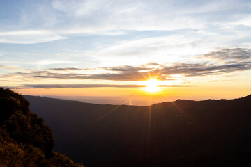 Landscape of Morning Mist with Mountain Layer at north of Thailand. mountain ridge and clouds in rural jungle bush forest