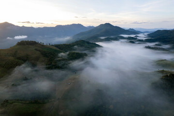 Landscape of Morning Mist with Mountain Layer at north of Thailand. mountain ridge and clouds in rural jungle bush forest