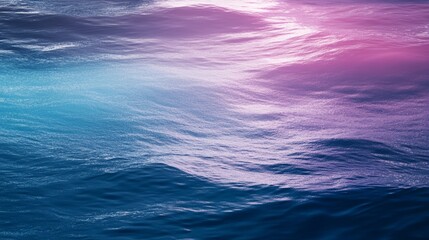 Fototapeta premium A serene ocean surface shimmering with shades of blue and pink, reflecting light and creating a tranquil atmosphere.