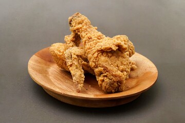Fried Chicken breast hot crispy strips crunchy chicken tenders three pieces isolated on black background. Crispy fried chicken is a food made from fried chicken placed on a plate.