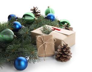 Fir branches with Christmas gift box, balls and cones on white background