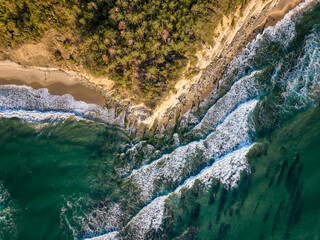 Aerial morning view of a picturesque beach with a long and empty sandbar and gentle sea waves bathed in morning sunlight on the Black Sea coast, Bulgaria. © Jess_Ivanova