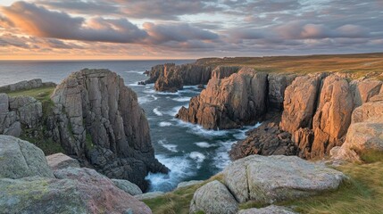 Fototapeta premium Dramatic cliffs and rocky coastline at sunset with a stormy sea.