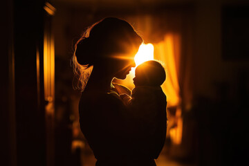 A woman is holding a baby in her arms