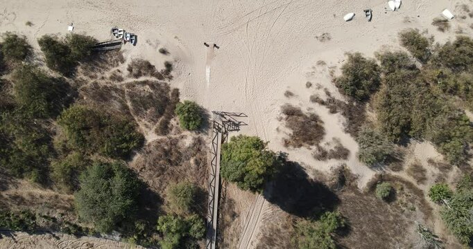 Drone footage of the beach of Bonanza, at the mouth of the Guadalquivir river. There are small fishing boats on the shore and some sport canoes, in the background you can see the Do&ntilde;ana Natural Park.