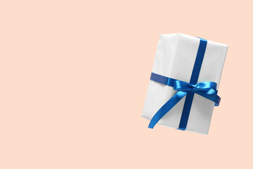 Flying gift box on beige background