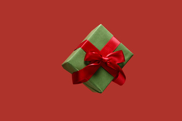Flying gift box on red background
